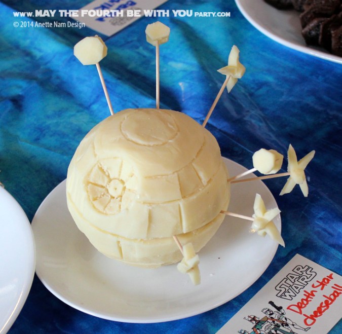 Star Wars Food: Carved Death Star Cheese Ball with X-Wings and TIE fighters /// Check out our blog for lots of Star Wars Party food recipes and downloadable labels! Great for a Birthday Party or a May the Fourth be with you Party. /// #starwars #starwarsparty #maythefourthbewithyou #starwarsbirthday #starwarsfood #cheese #deathstar #xwing #tiefighter maythefourthbewithyoupartyblog.com