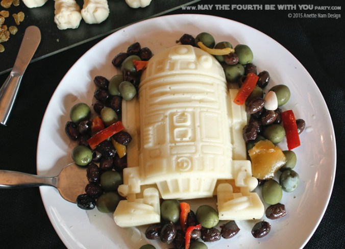 Star Wars Food: R2-D2 Mozzarella Cheese with Olive Mix (from silicone mold) /// Check out our blog for lots of Star Wars Party food recipes and downloadable labels! Great for a Birthday Party or a May the Fourth be with you Party. /// #starwars #starwarsparty #maythefourthbewithyou #starwarsbirthday #starwarsfood #r2d2 #mozzarella #olives #cheese maythefourthbewithyoupartyblog.com